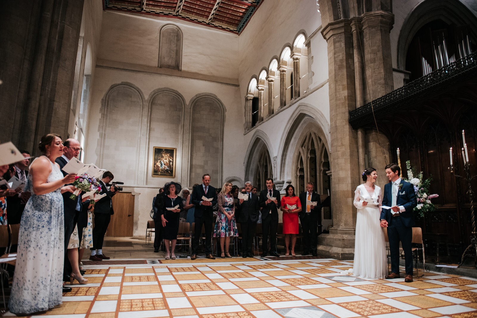 Bride and groom look at each other and smile during wedding cere