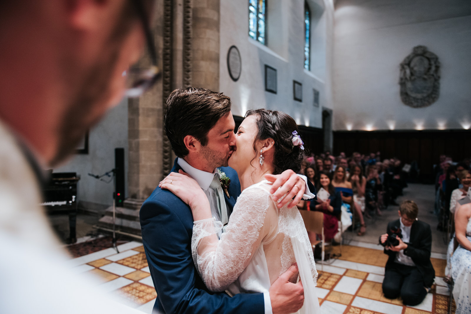 Bride and groom first kiss during wedding ceremony at Jesus Coll