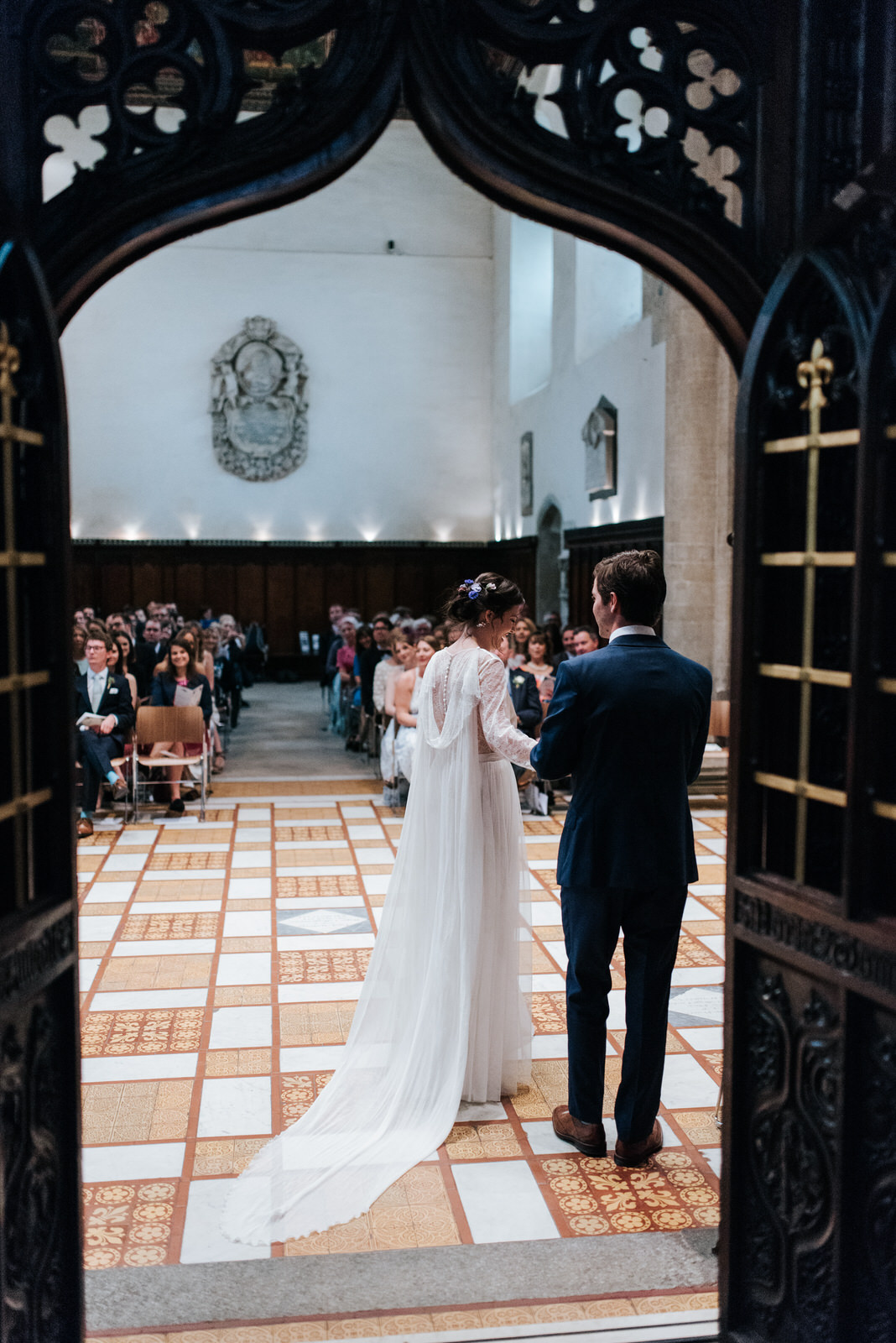 Bride and groom walk out towards guests during wedding ceremony