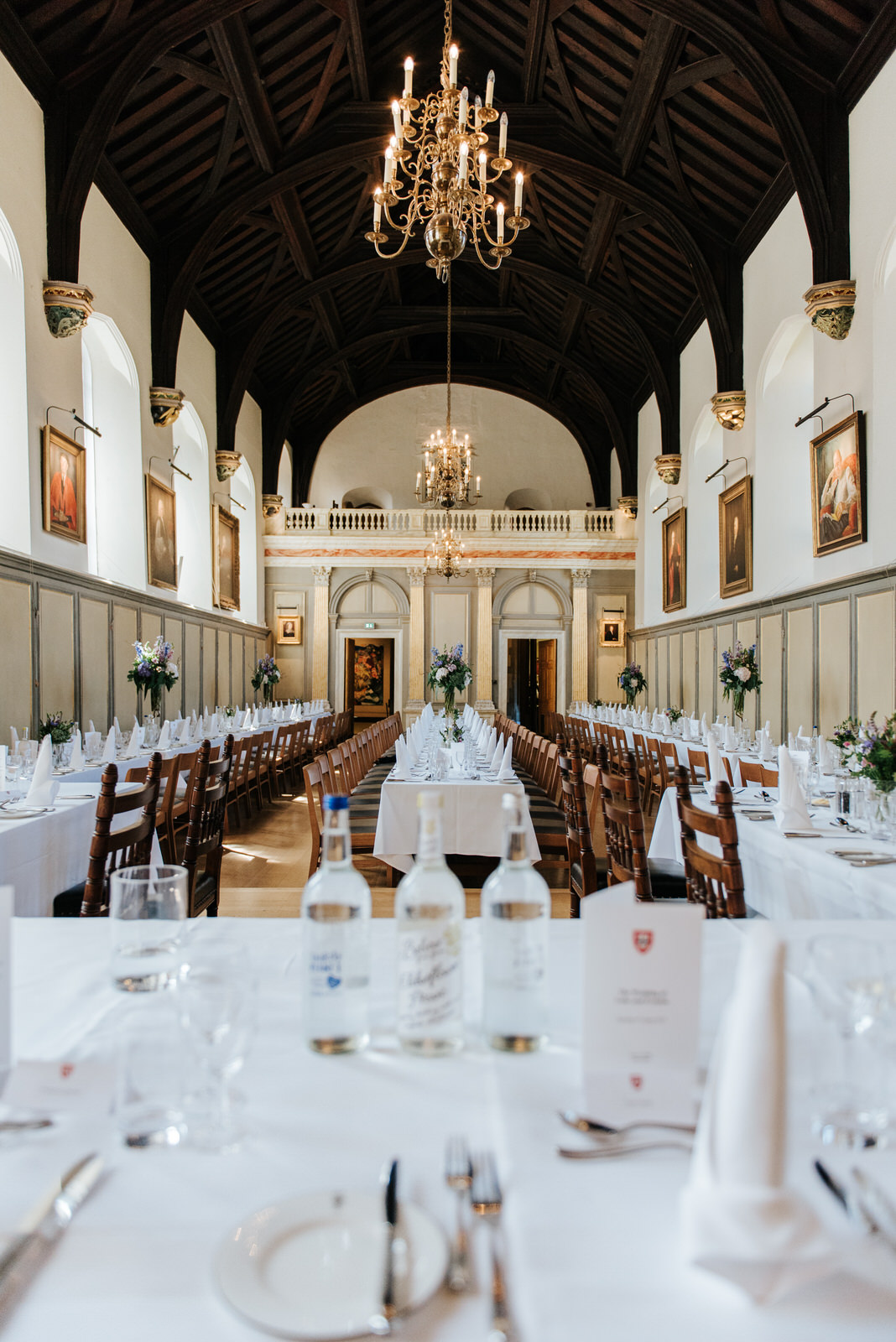 Wide shot of long tables and wedding decoration inside Jesus Col