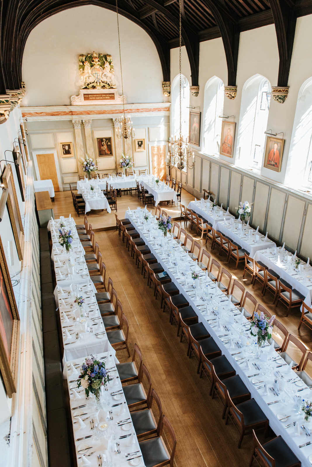 Wide shot of long tables and wedding decoration inside Jesus Col