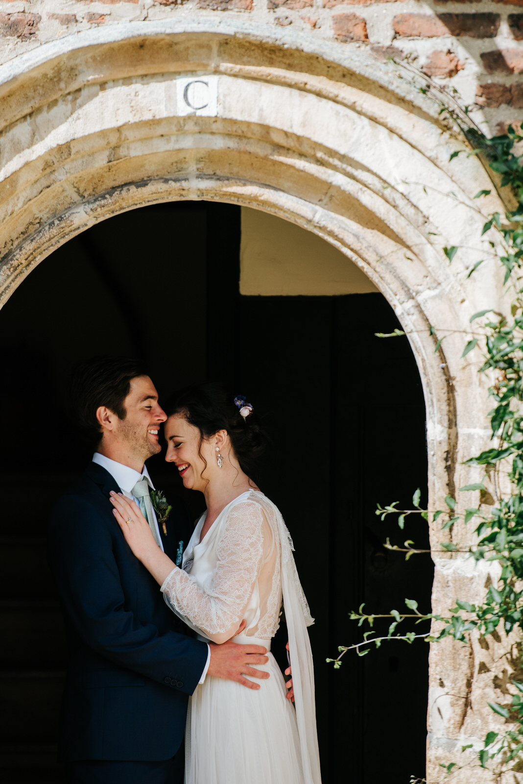 Bride and groom embrace each other romantically during wedding c