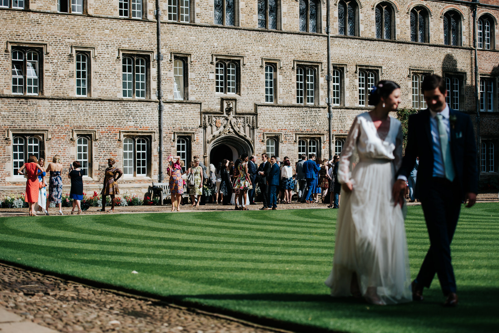 Bride and groom look towards guests as they enjoy themselves on 