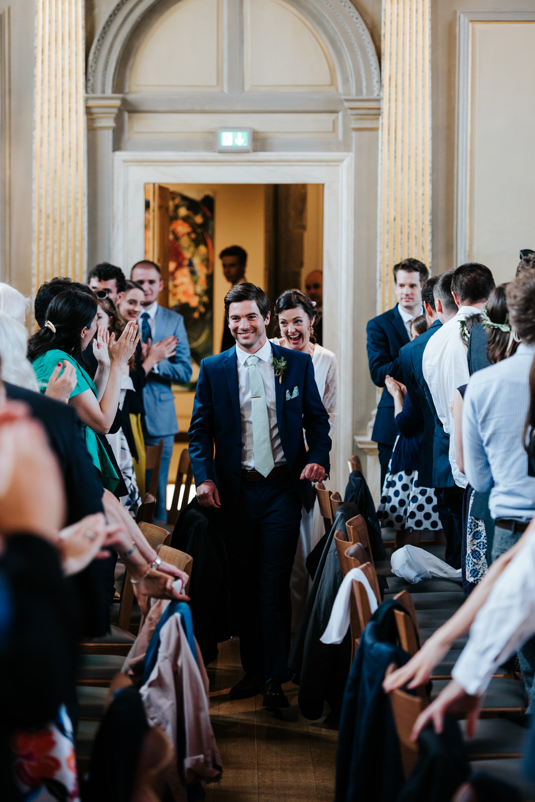 Bride and groom make their grand entrance into Jesus College Din