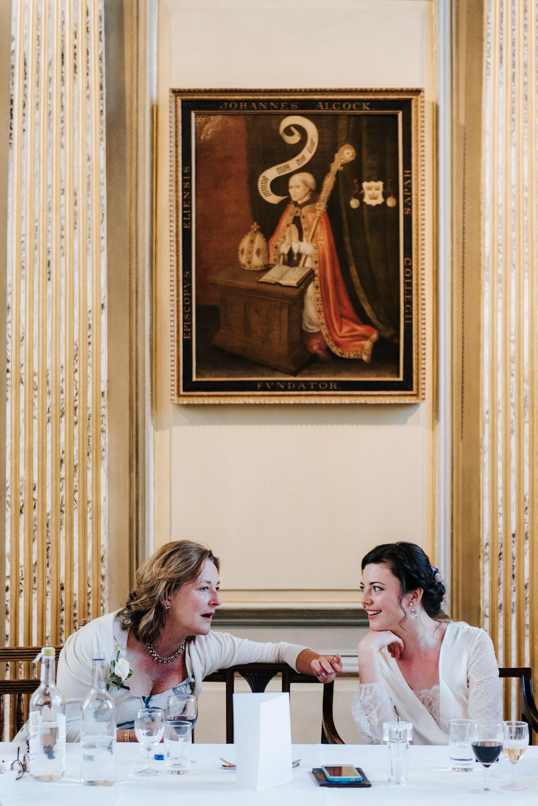 Bride listens attentively to what her mother has to say during w