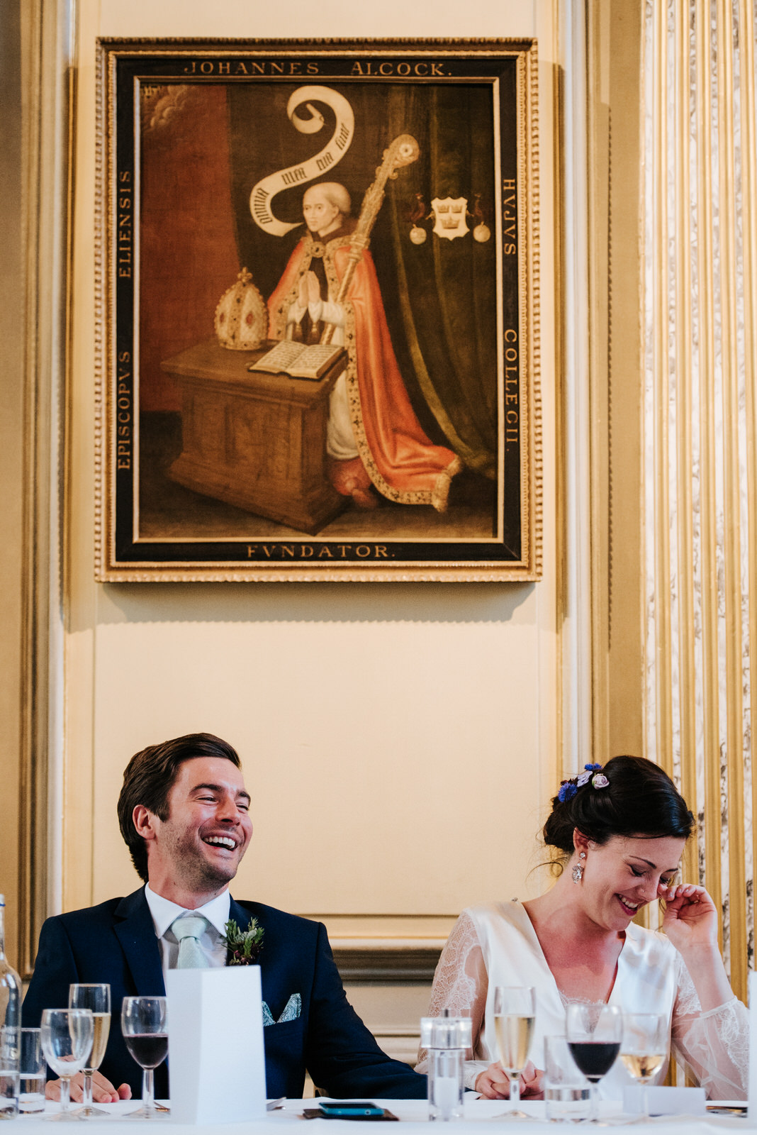 Bride and groom laugh out loud during speeches