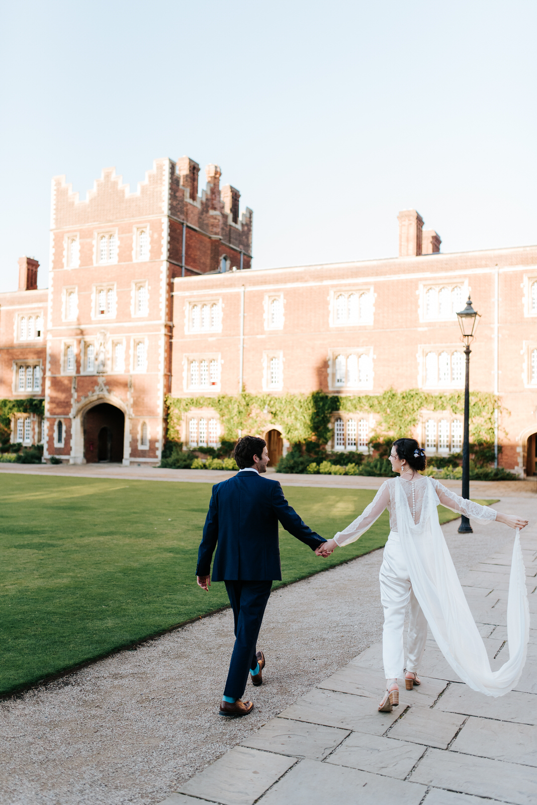 Bride and groom look at each other as they walk through Chapel C