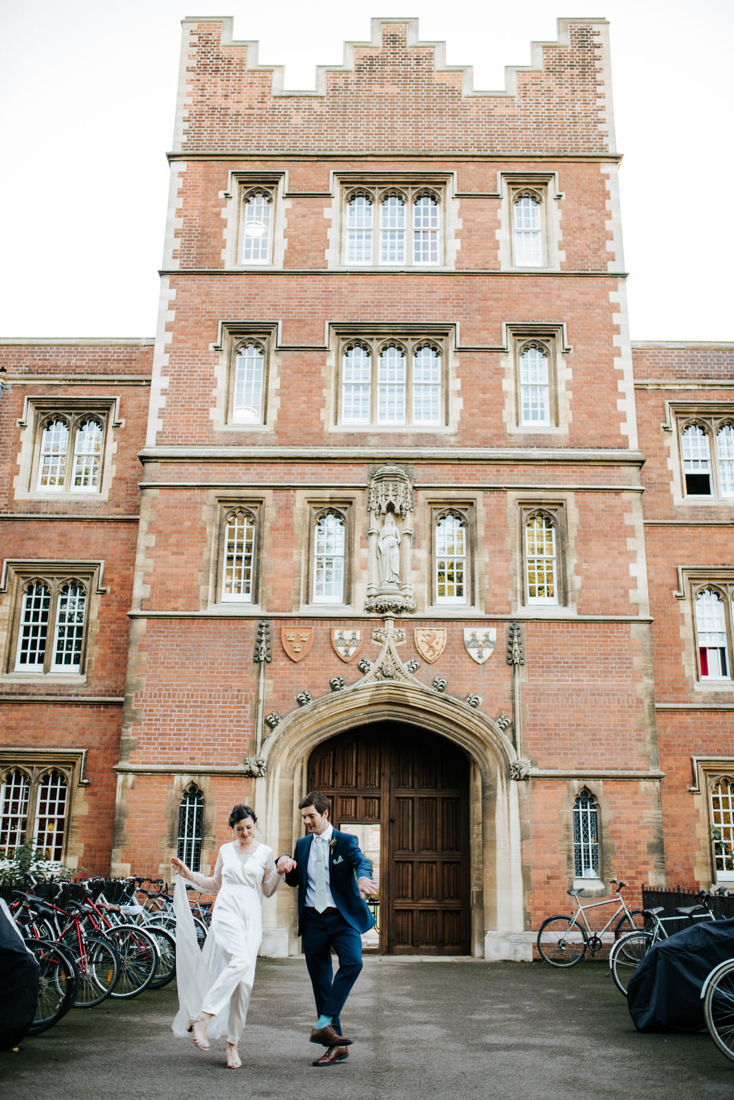 Bride and Groome exit Jesus College Chapel Court as they dance