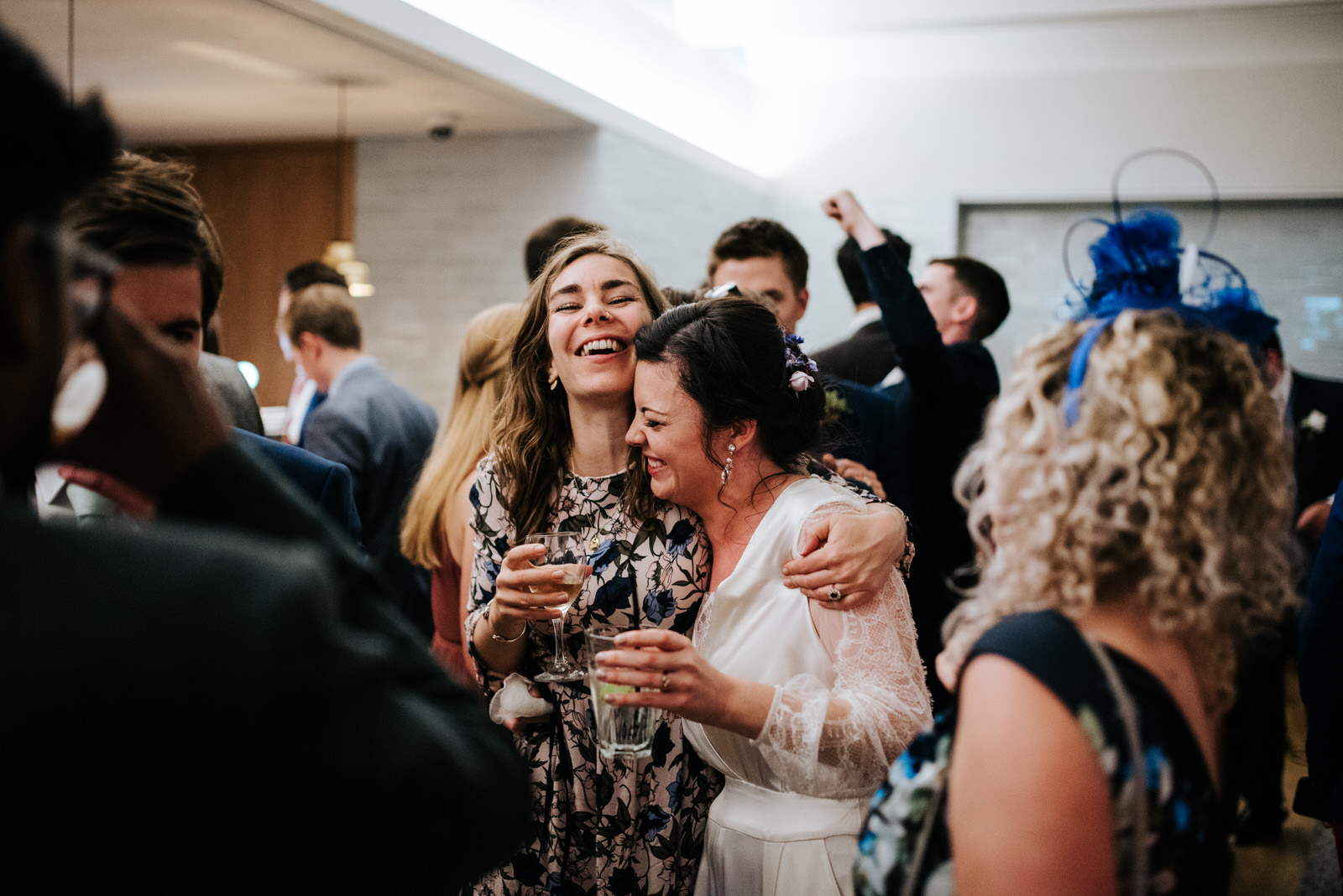 Bride hugs close friend emotionally at Jesus College Wedding