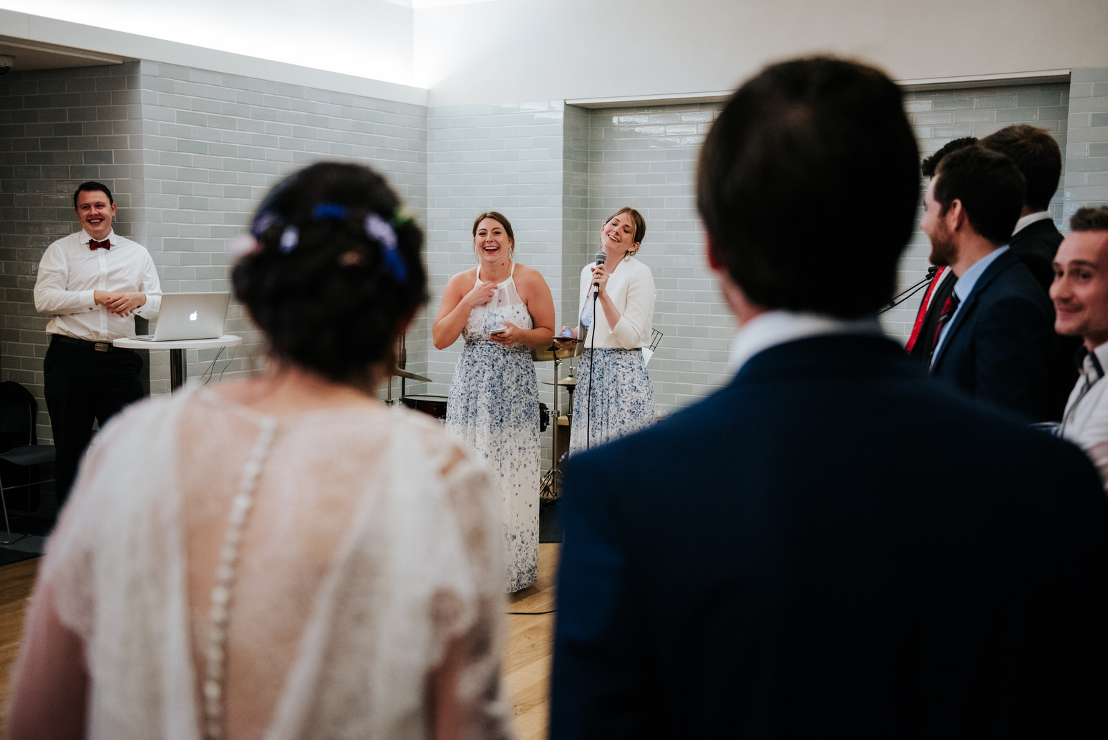 Sisters of the bride and groom deliver joyous speech in front of