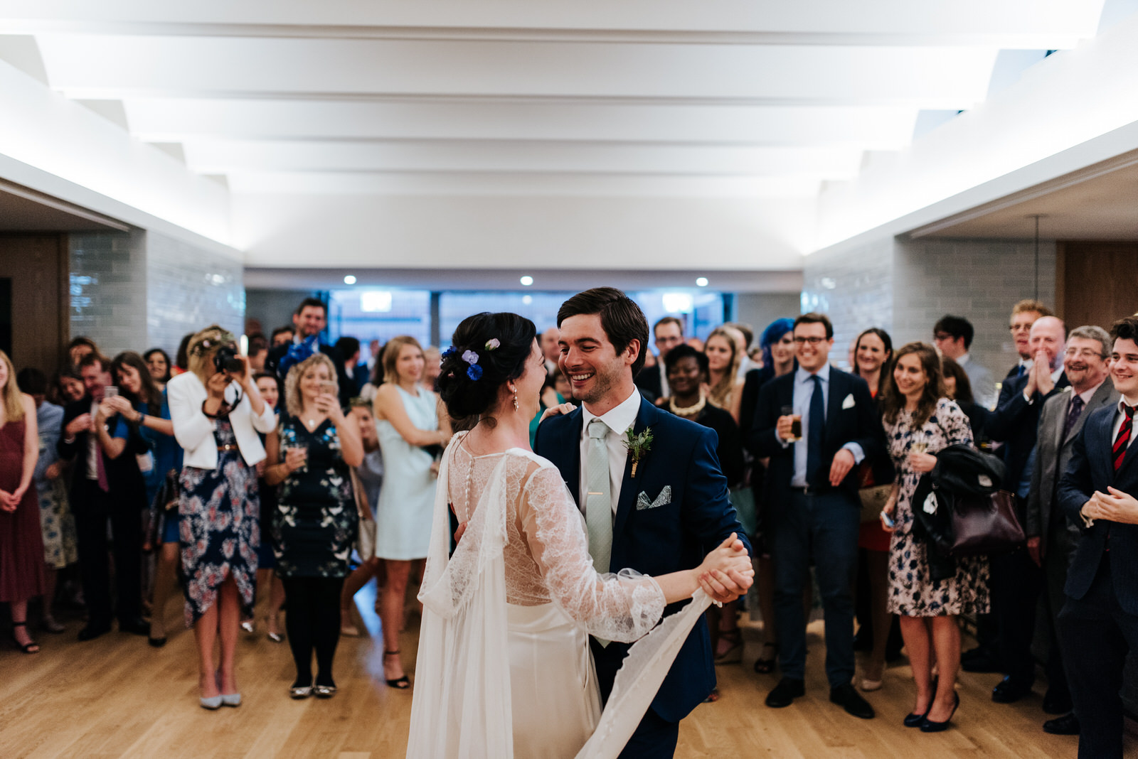 Bride and groom have their first dance in front of guests at Wes