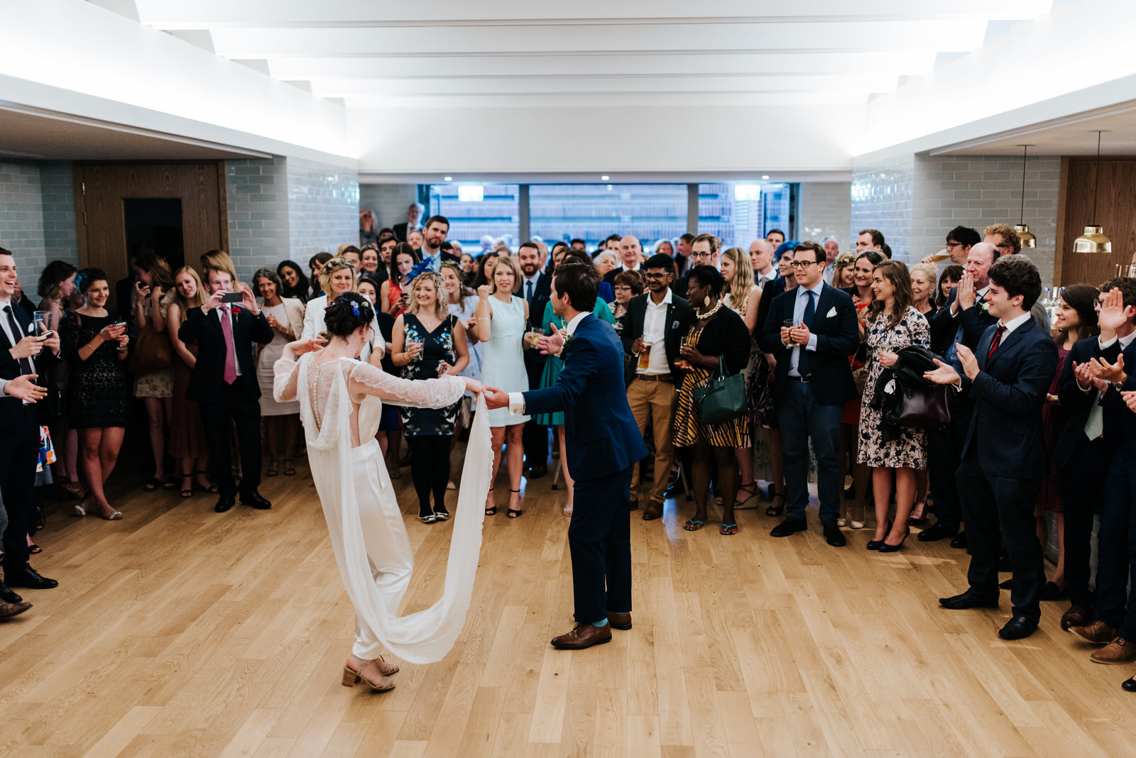 Bride and groom have their first dance in front of guests at Wes