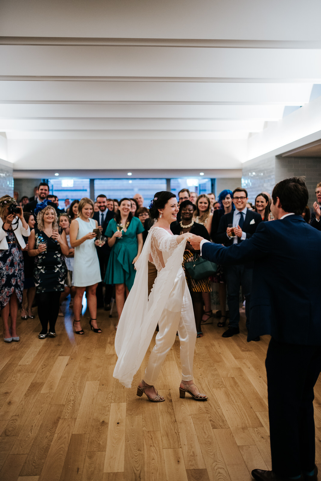 Bride and groom have their first dance in front of guests at Wes