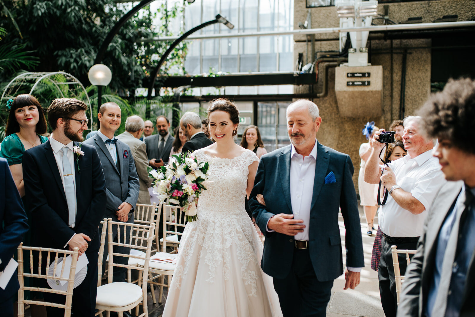 Bride and her uncle approach the end of the aisle as bride meets