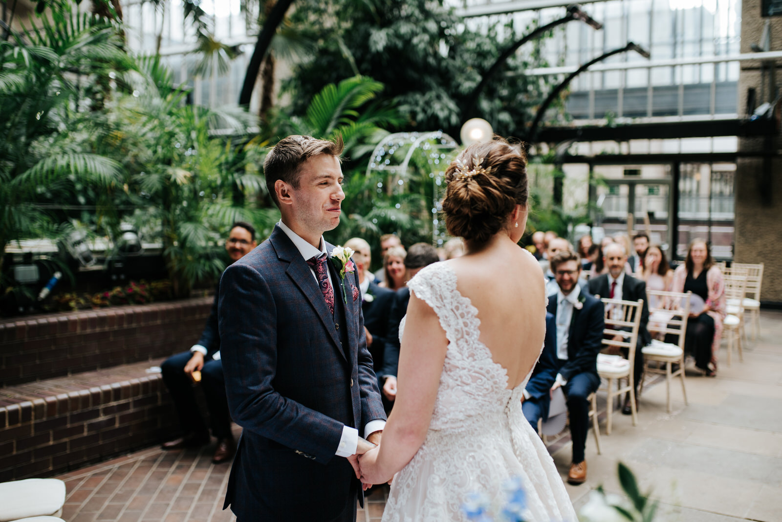 Groom reacts to seeing bride for the first time by holding hands