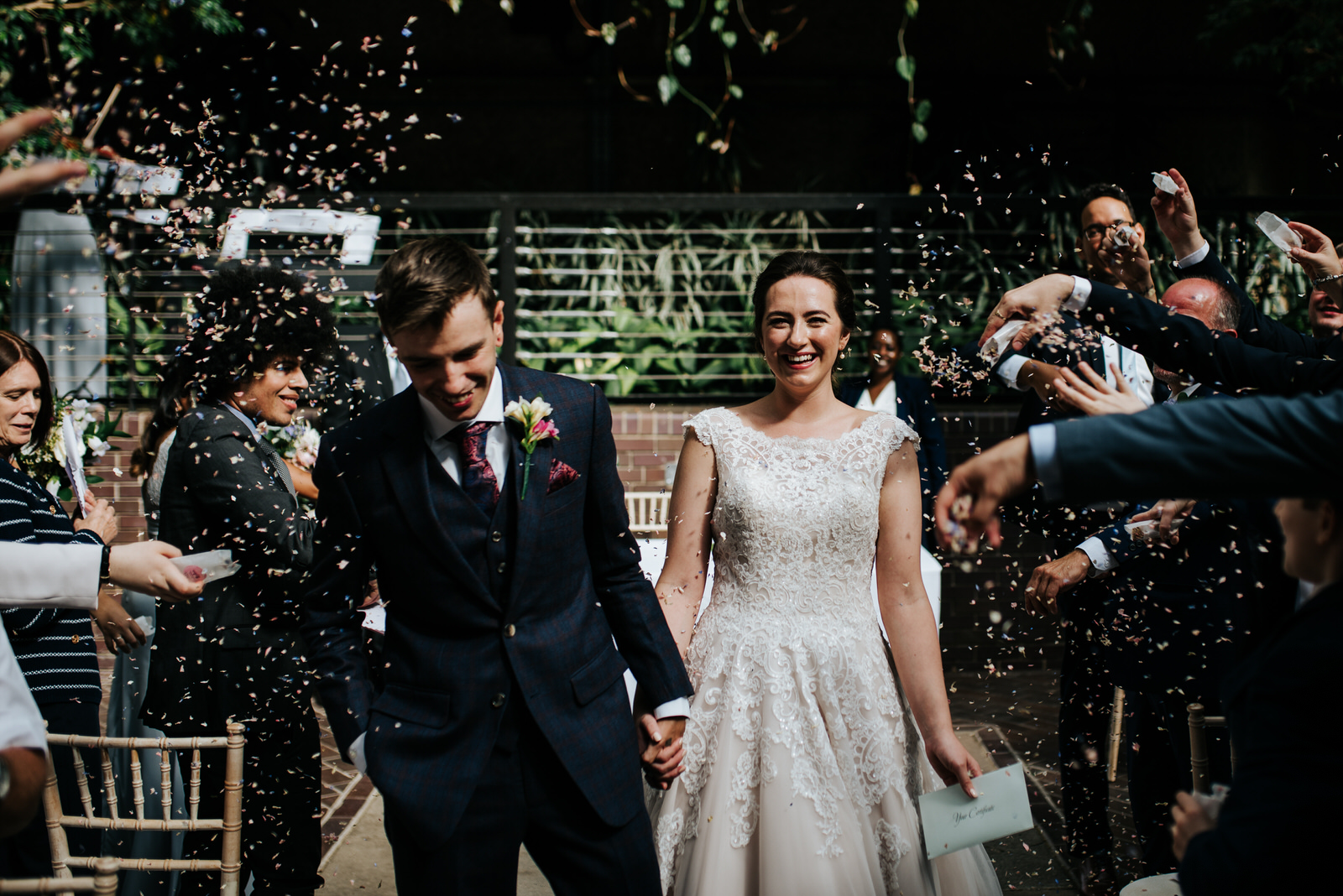 Bride and groom exit down the aisle as husband and wife as guest