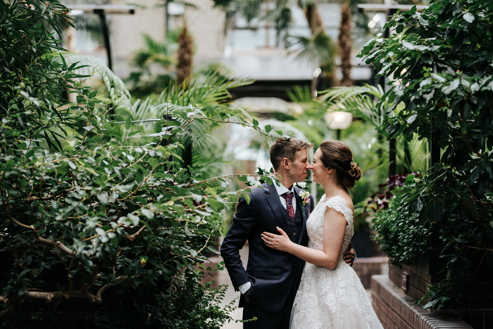 Cute photograph of bride and groom touching noses and smiling