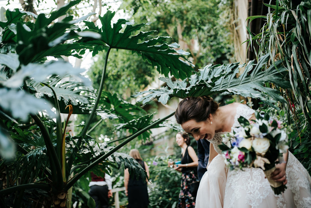 Bride laughs as she dodges massive green leaf on her way to wedd