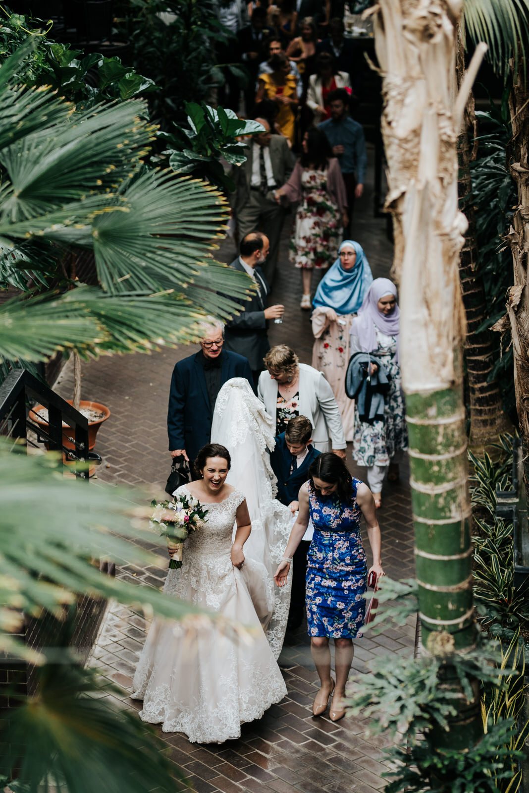Wide photograph from above of bride leading guests to wedding re