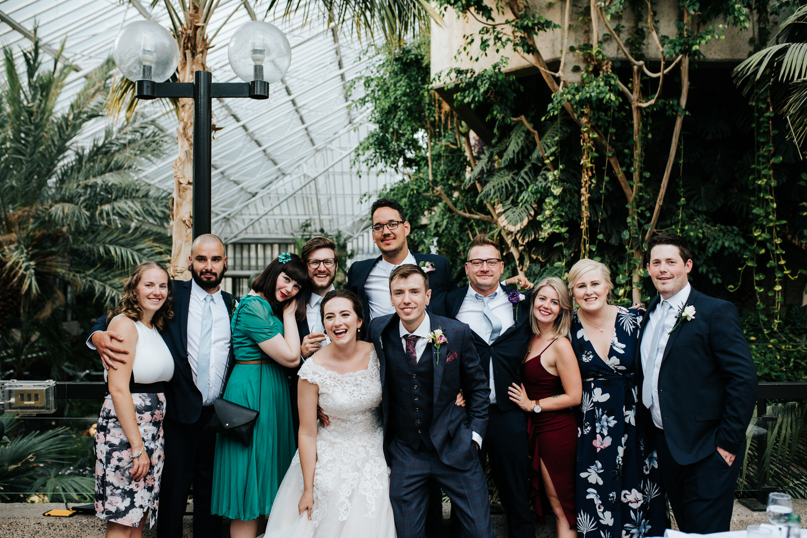 Posed group photograph of bride, groom and a variety of friends