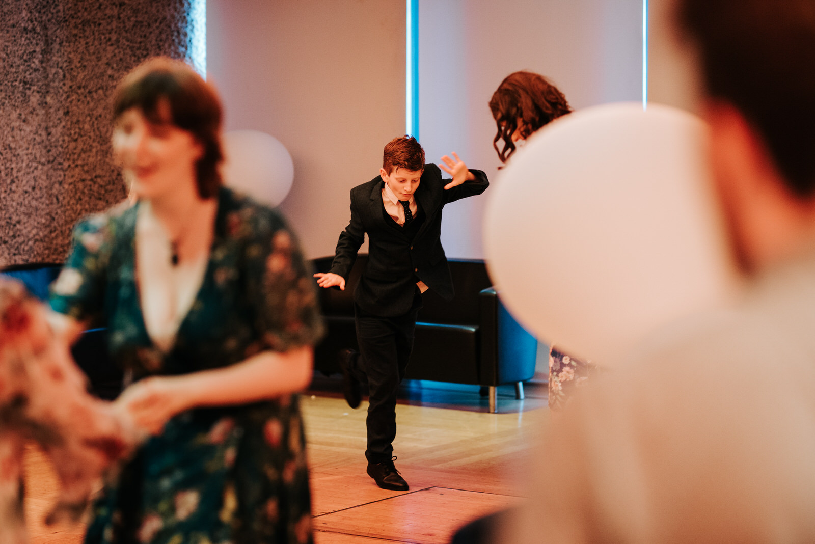 Young guest performs cool dance move as the party begins