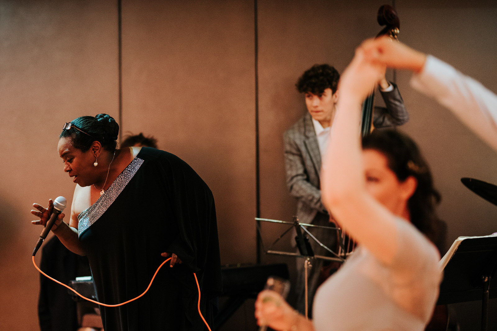 Lead band member is caught up in the moment as she leans into mi
