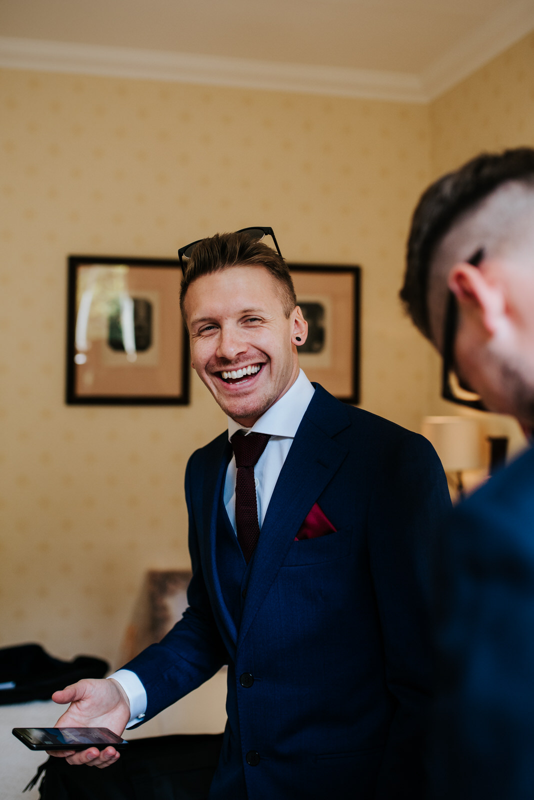 Groomsman smiles at camera cheeky