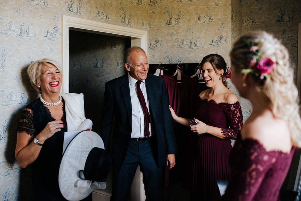 Bride's mom, step-dad and two bridesmaids share a special moment