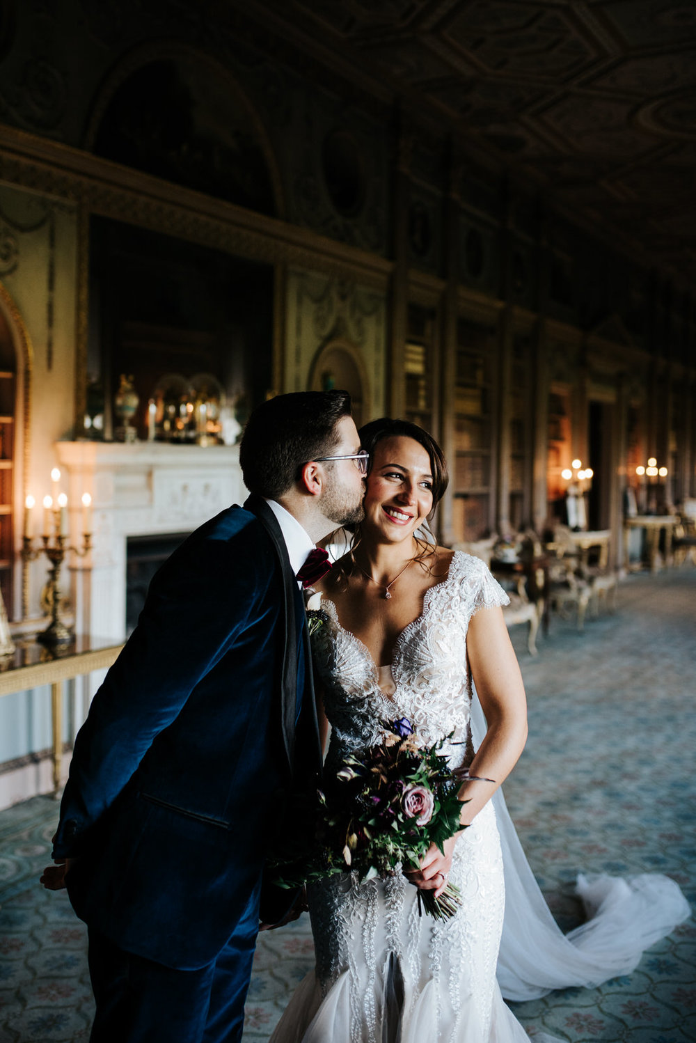 Bride and groom smile as they have their photo taken in Syon House's Library room 
