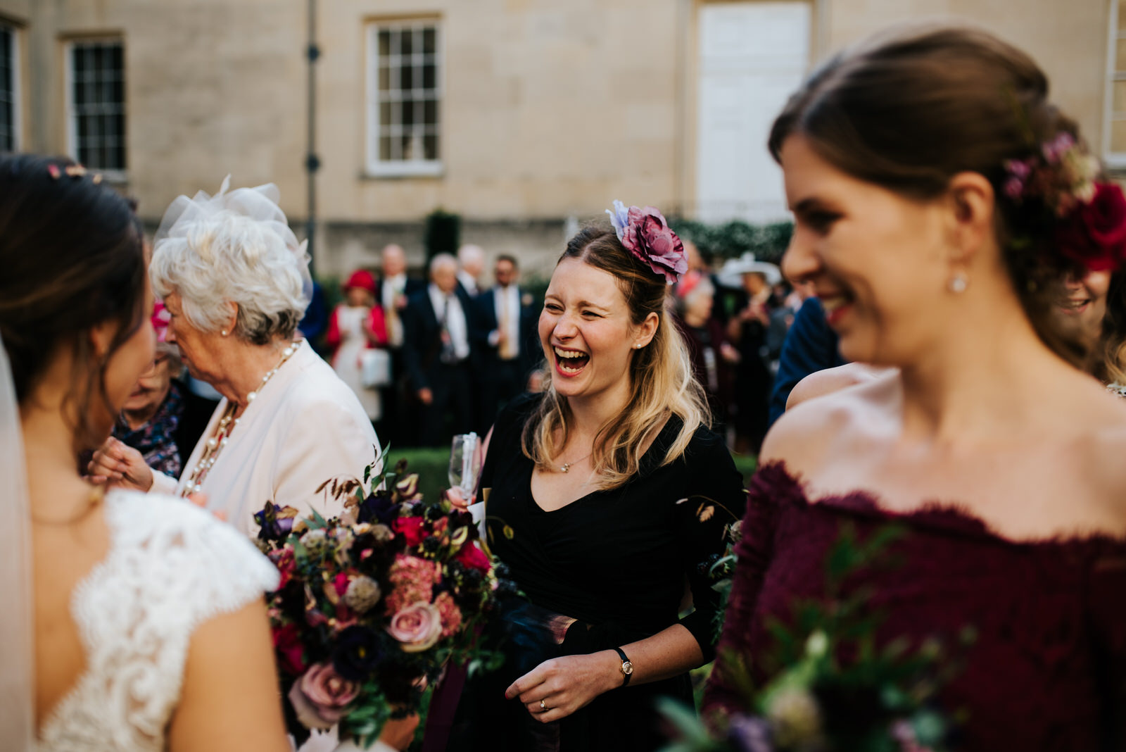 Candid moment of guests saying hello to bride and groom after wedding ceremony