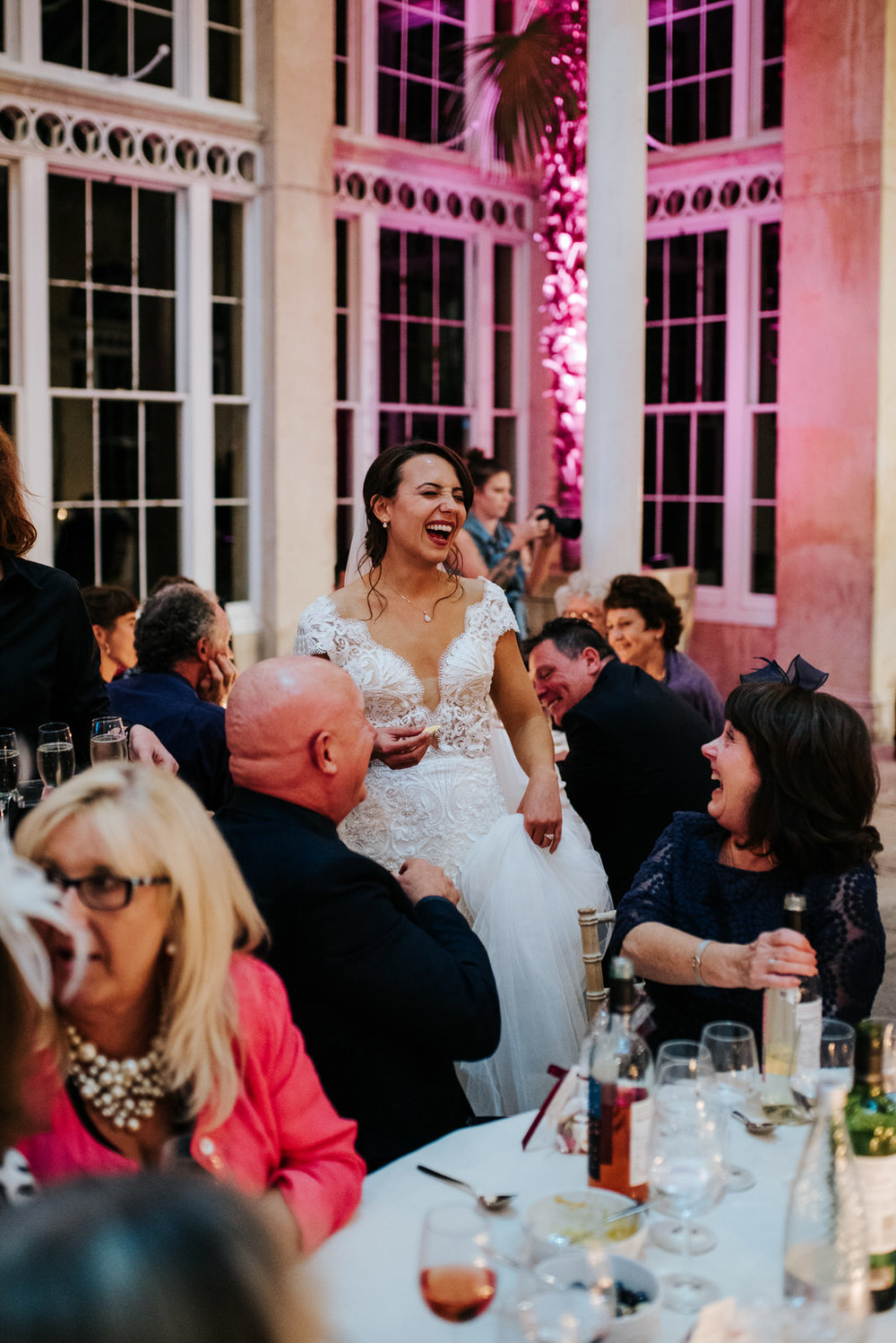 Bride can't contain laughter as she goes around tables saying hello to her guests