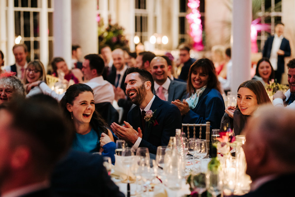 Groom's brother and sister can't contain laughter during his wedding speech