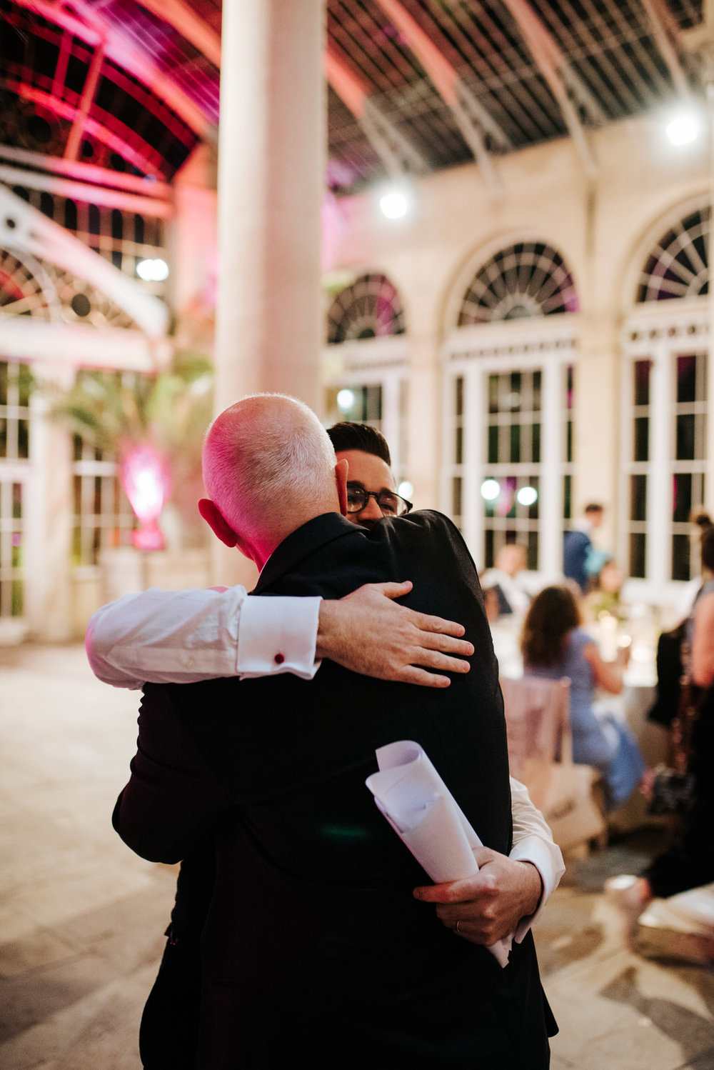 Groom tightly hugs his dad after he finishes his wedding speech 