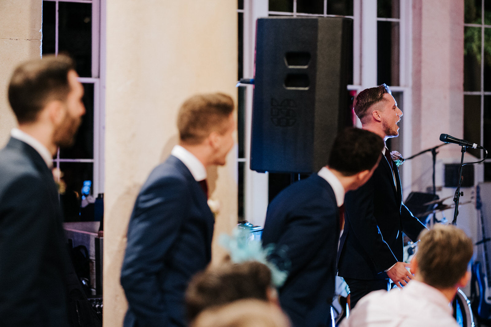 Groomsmen take turns delivering their wedding speeches