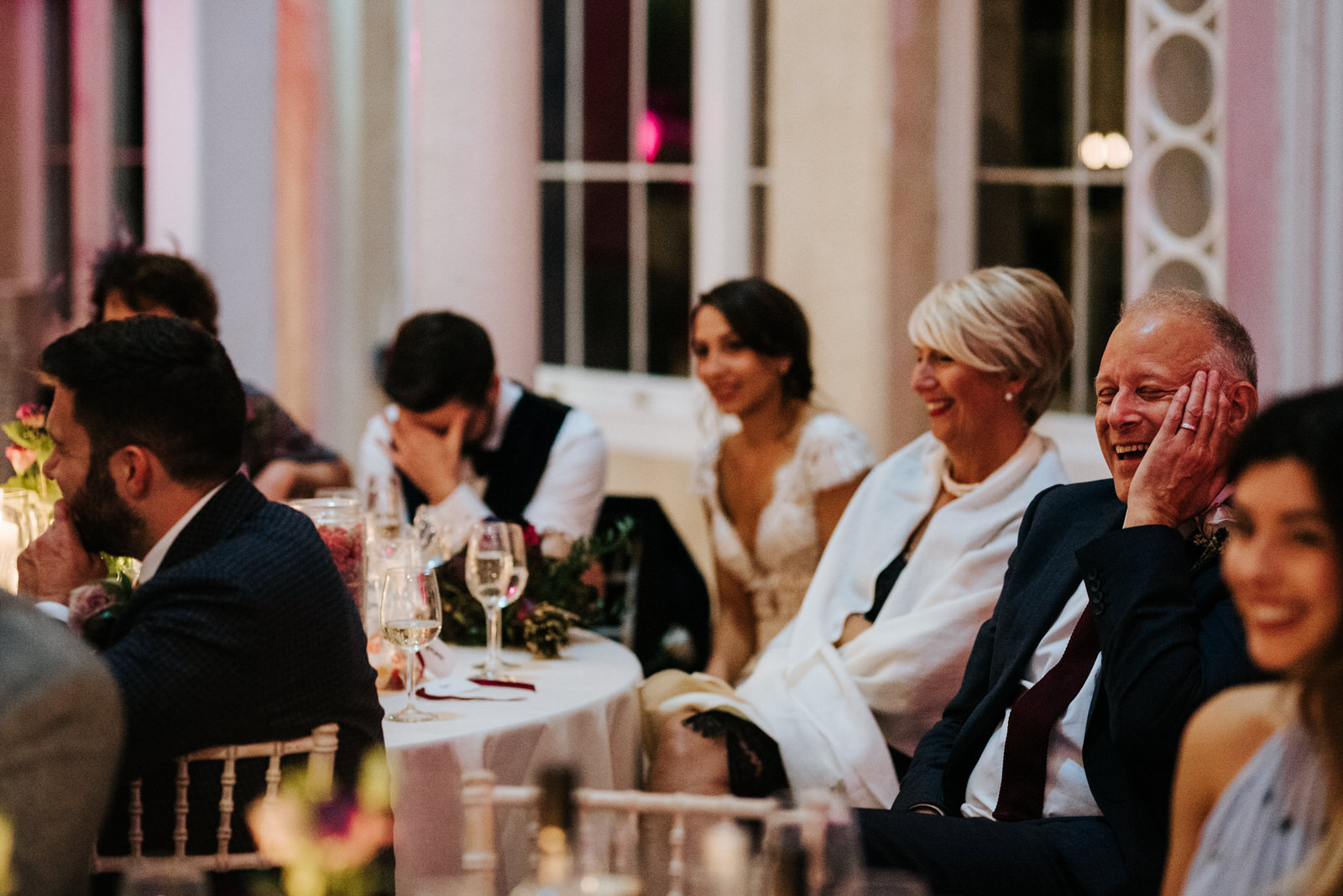 Something embarrassing is said as groom covers his face during speech