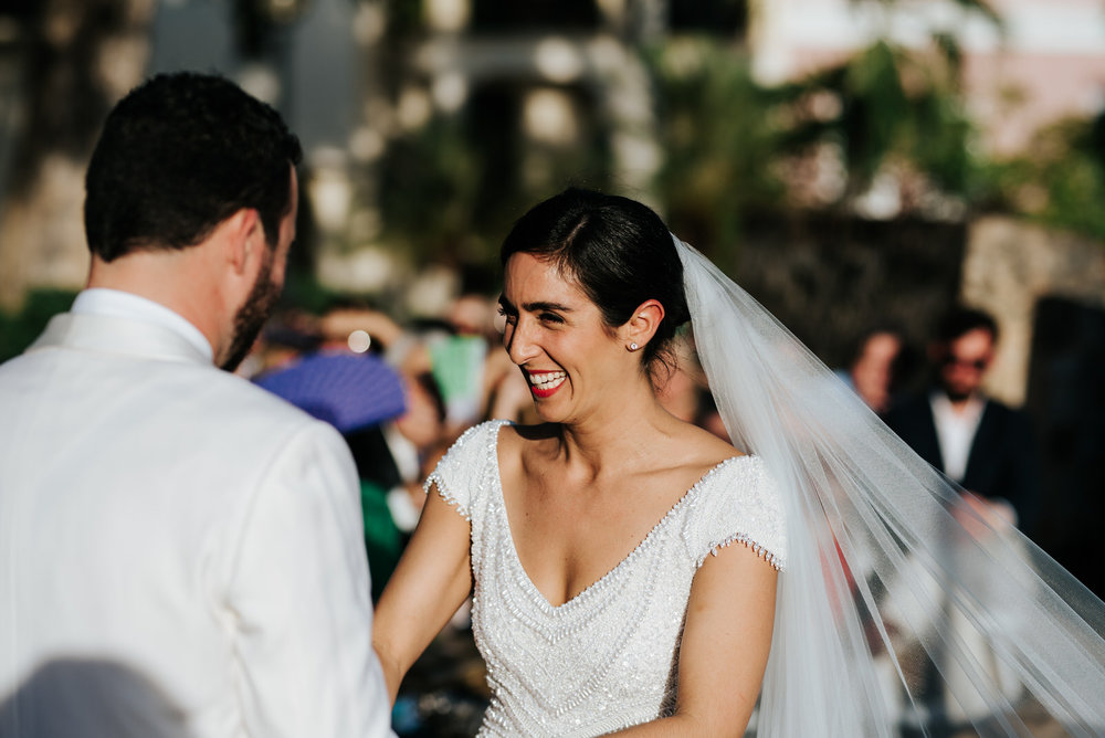  Bride cannot contain her laughter while holding hands with groom 