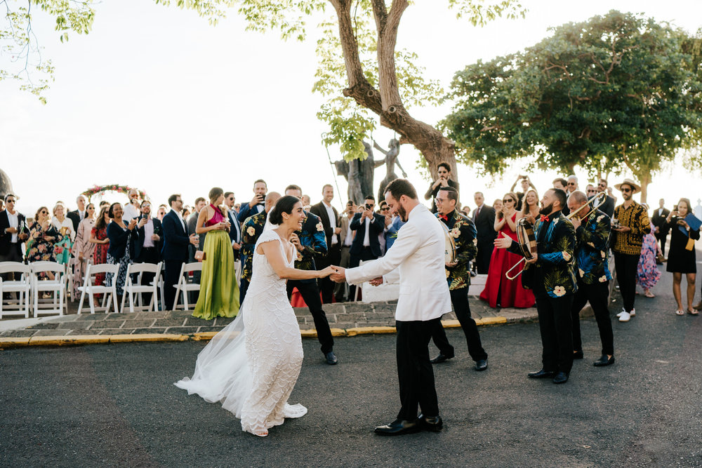  Bride and groom have walked back down the aisle and are seen dancing on the streets of Old San Juan after their wedding ceremony 