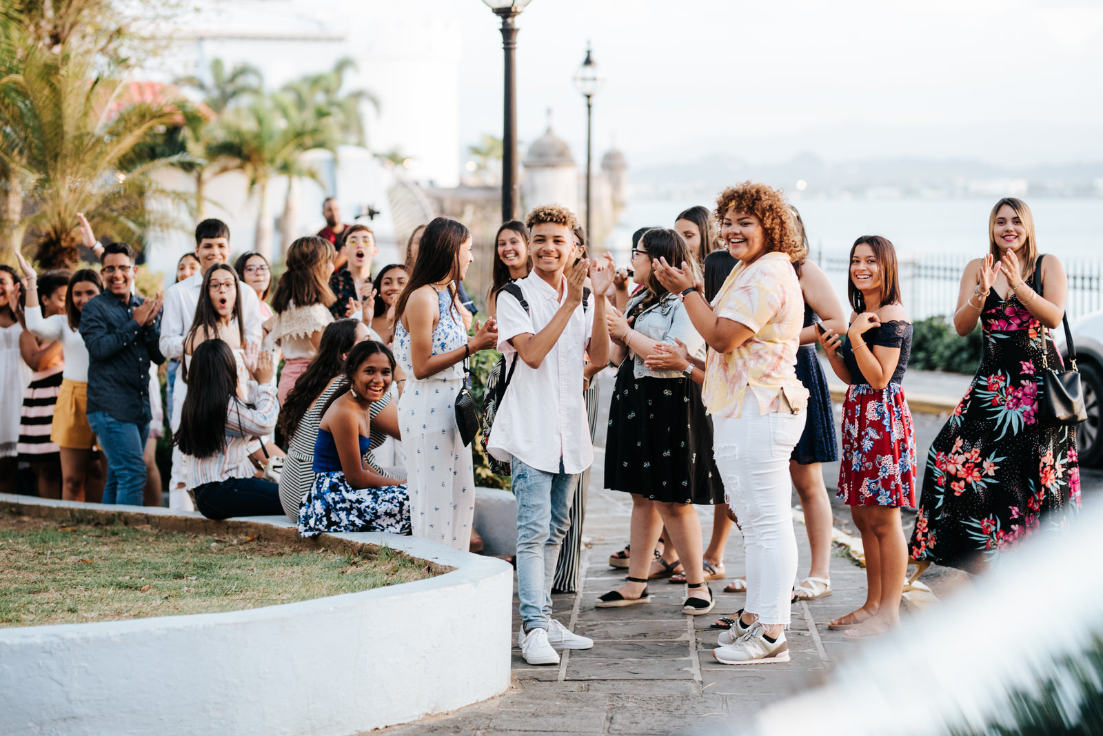 Group of students notices bride and groom and starts clapping from across the street