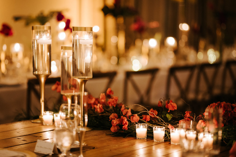  Close up photograph of decorations and candles on main table in the room 