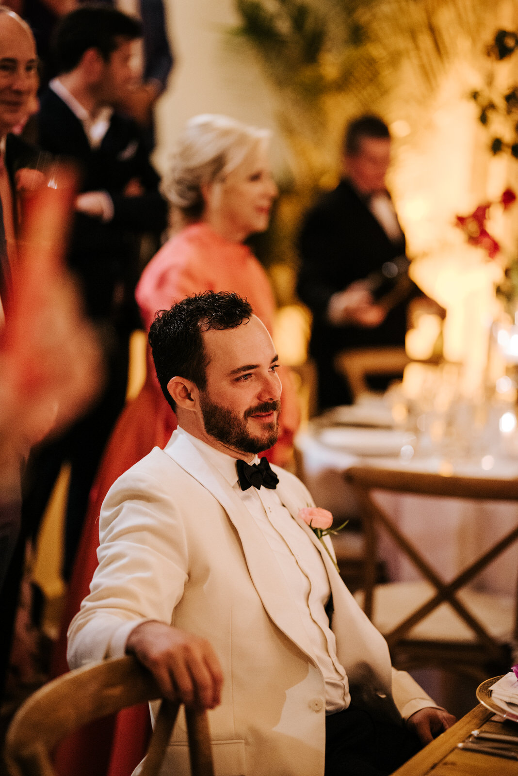 Groom sits and watches on as bride dances with his father in emotional dance