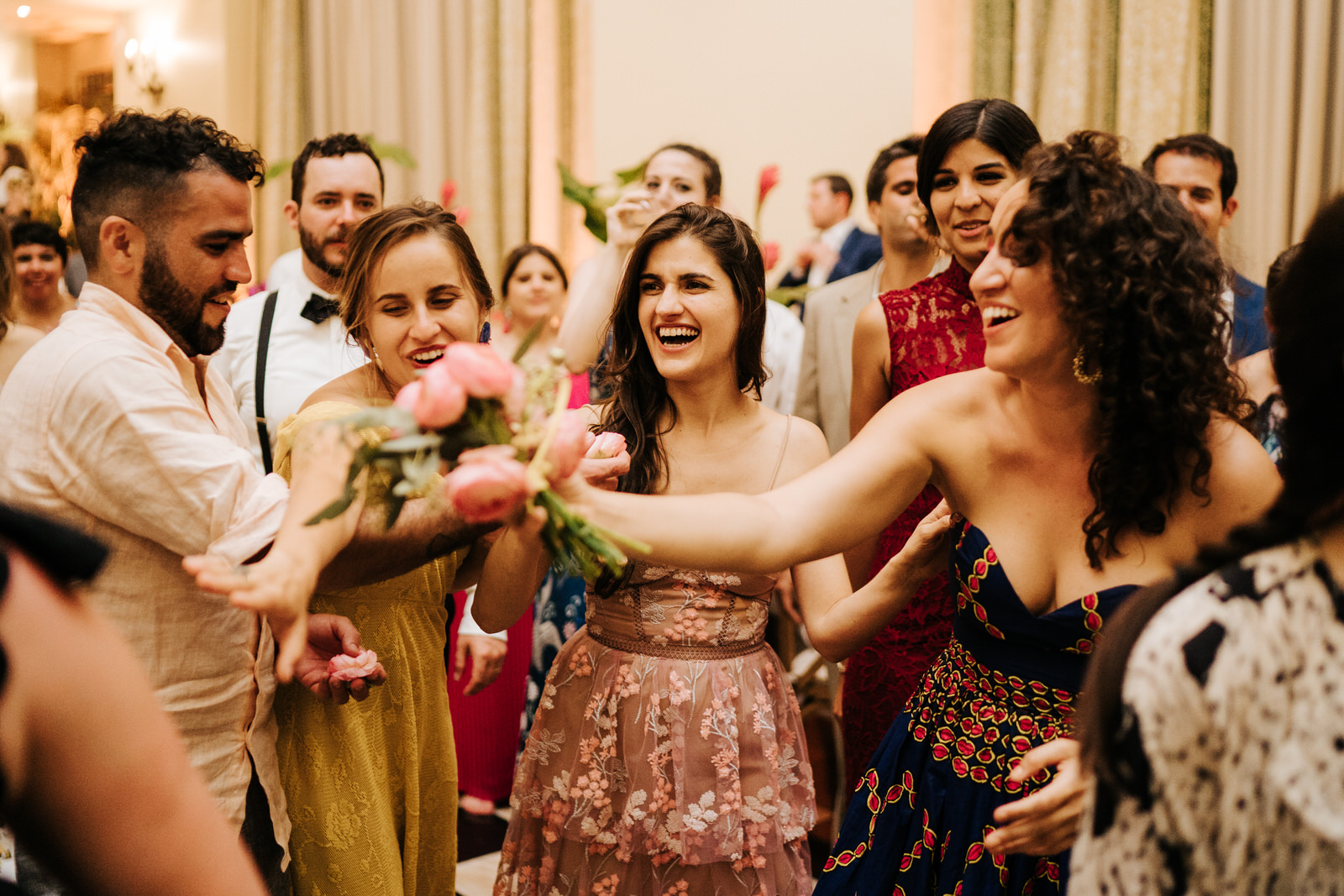 Photograph of the person who caught the bouquet and other friends laughing alongside her