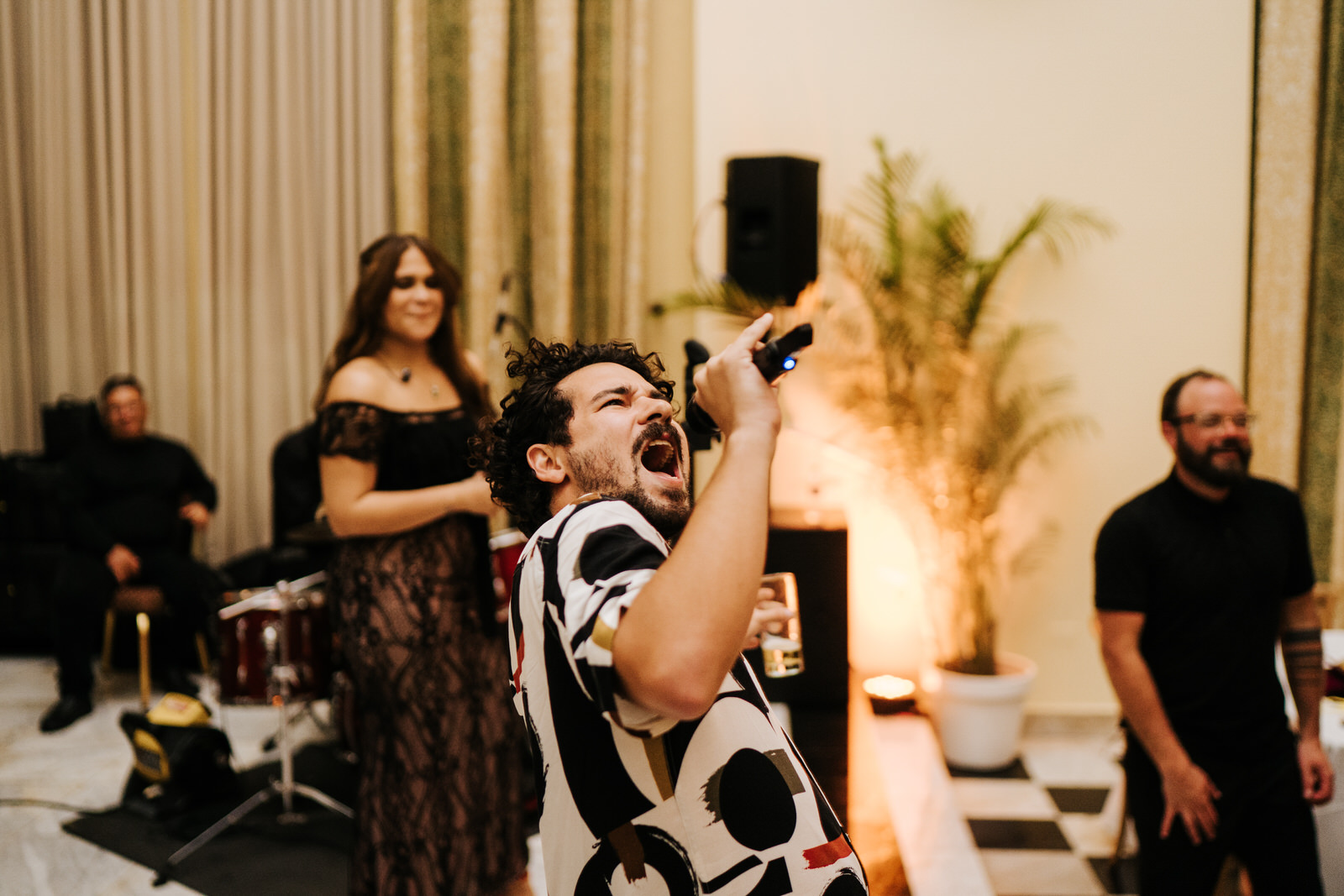 Friend of the couple takes over the microphone and starts freestyling