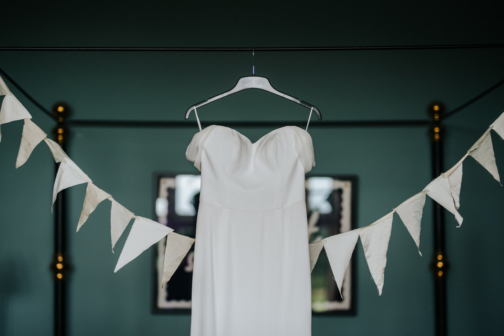  Bride's dressing hanging by bed in dressing room 