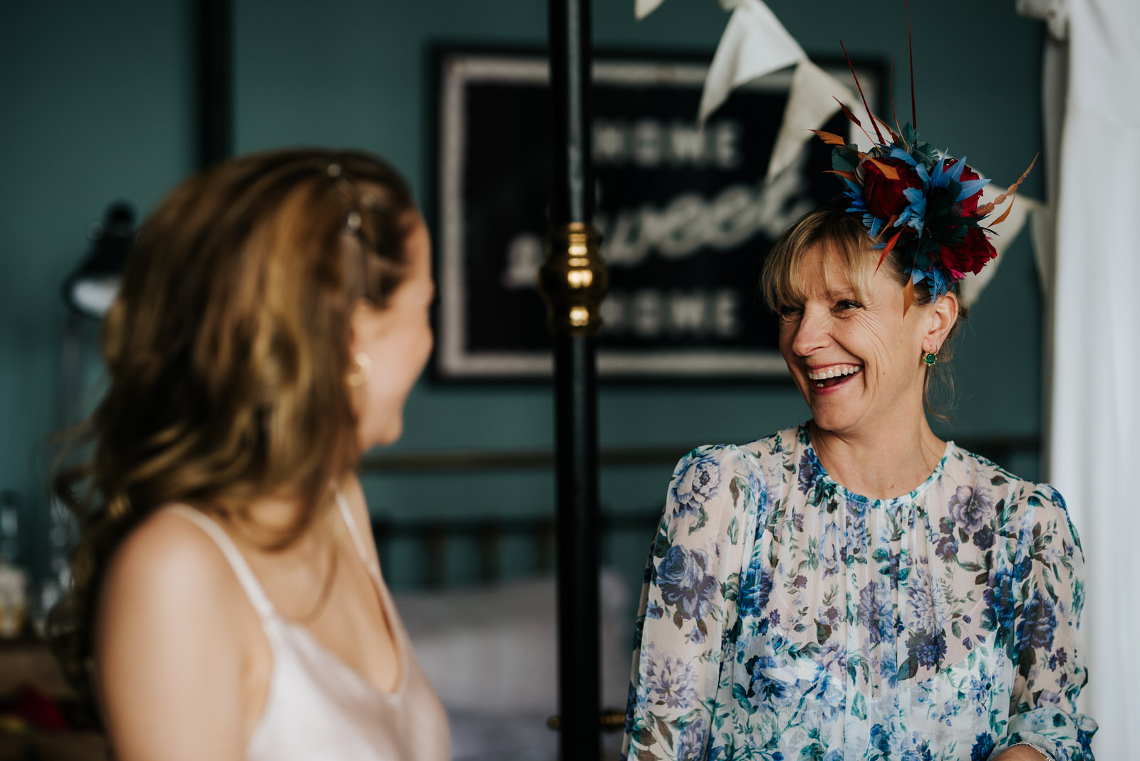  Bride's mother smiles at sister of the bride 