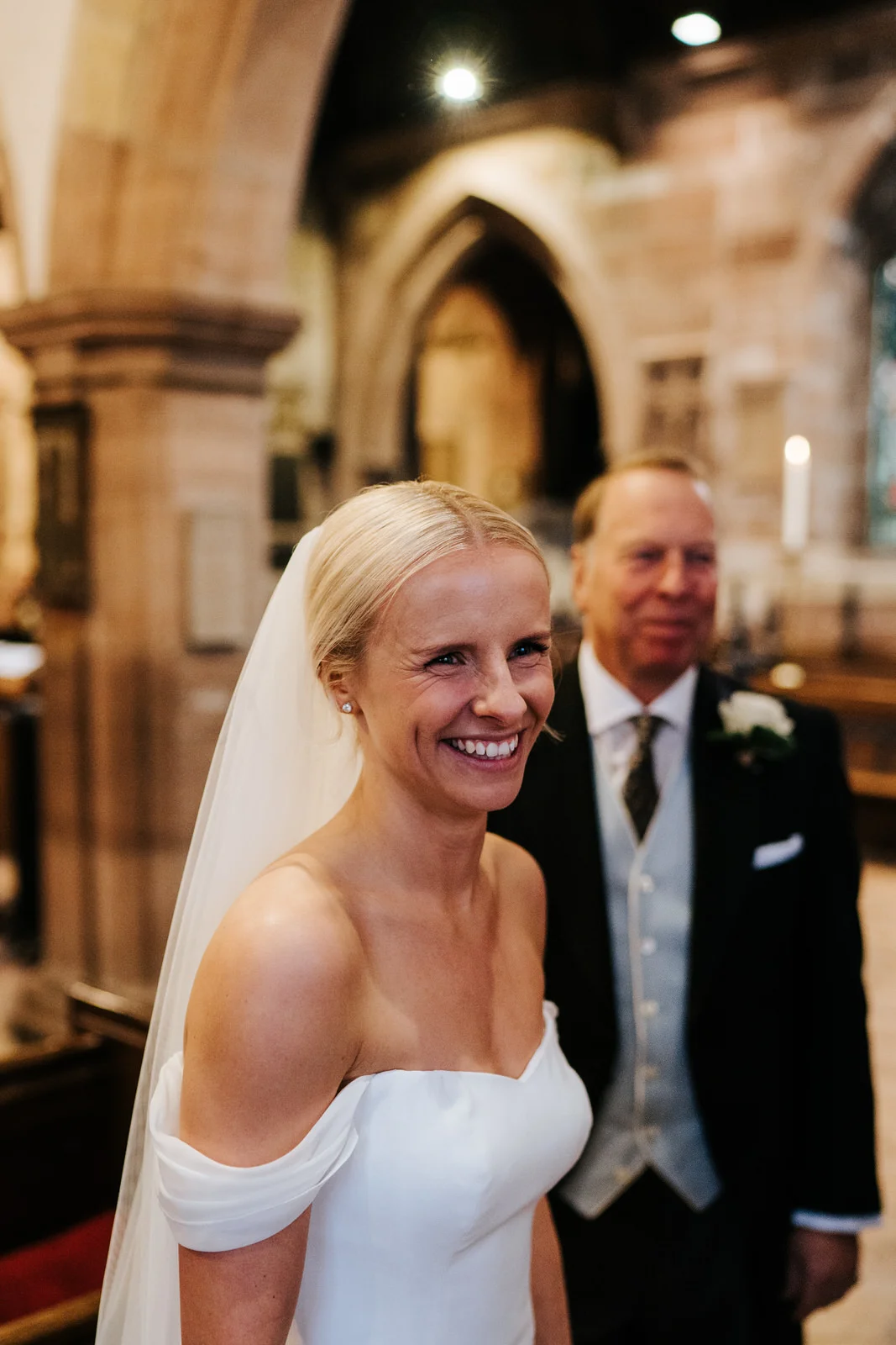 Bride smiles at someone off-camera