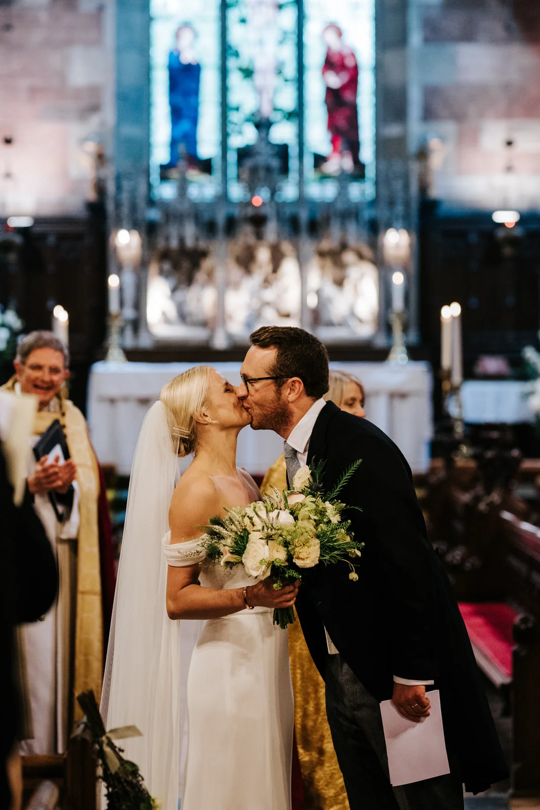 Bride and groom share first kiss before wedding ceremony ends