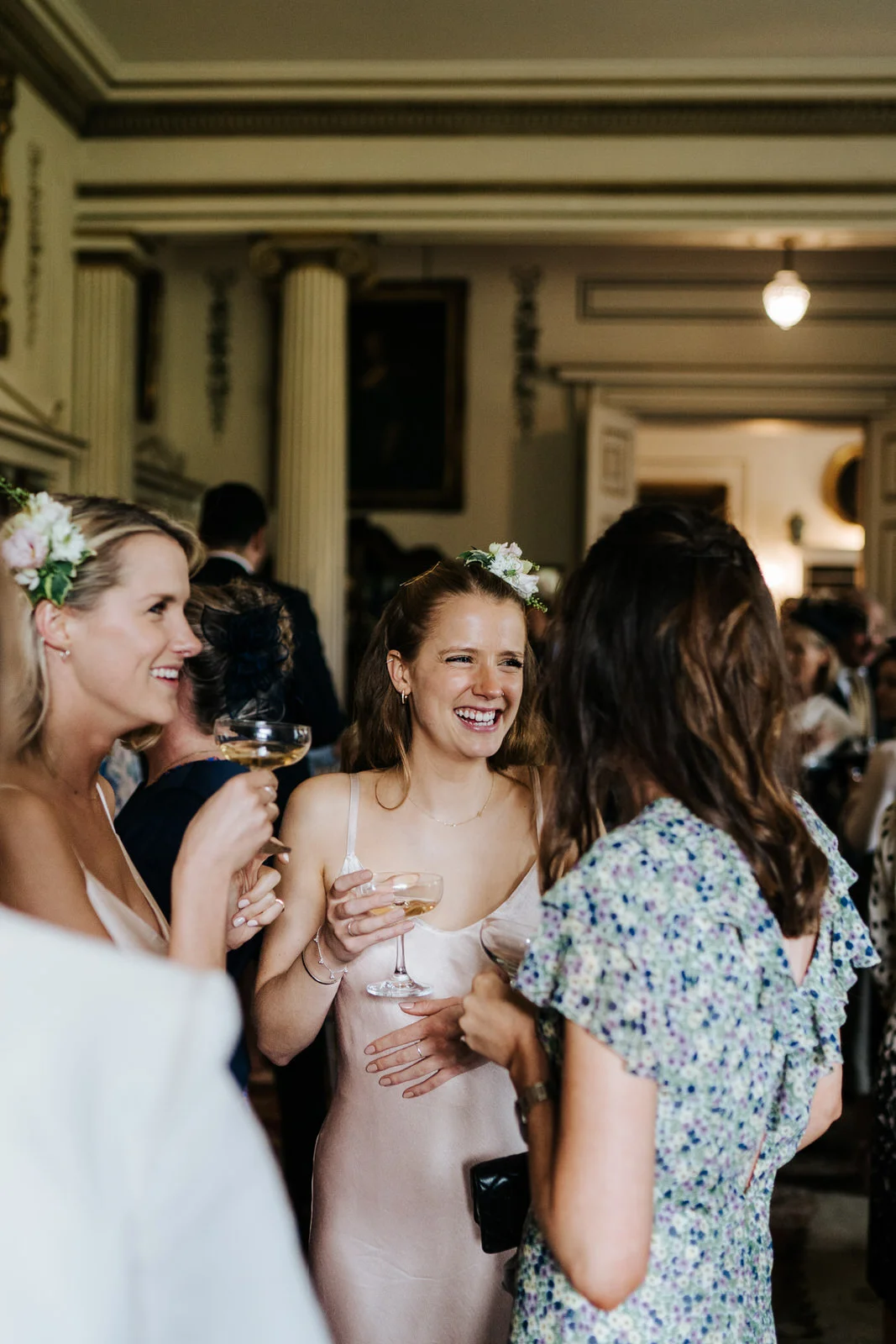 Bride's two sisters talk to a friend during the champagne reception