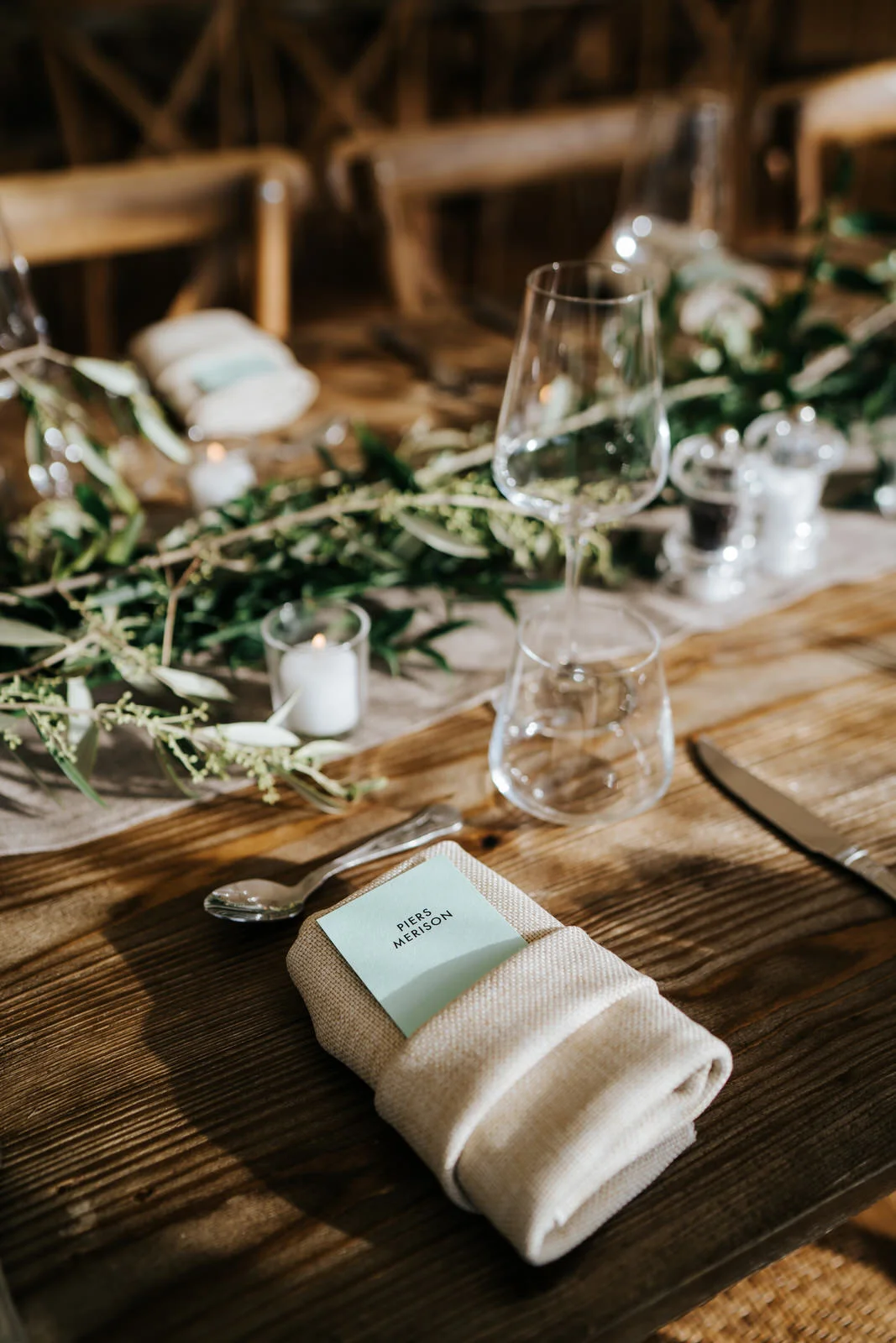 Close-up of placecard and decoration on wooden table to be used for wedding breakfast