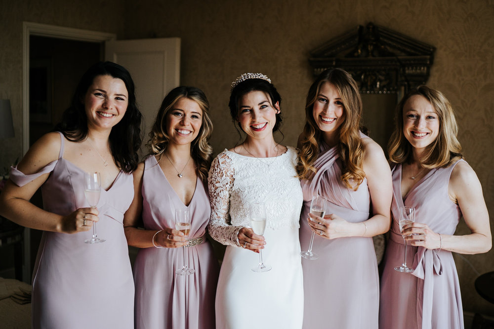  Group photograph of the bride and bridesmaids in beautiful, soft light at The Petersham in Richmond 
