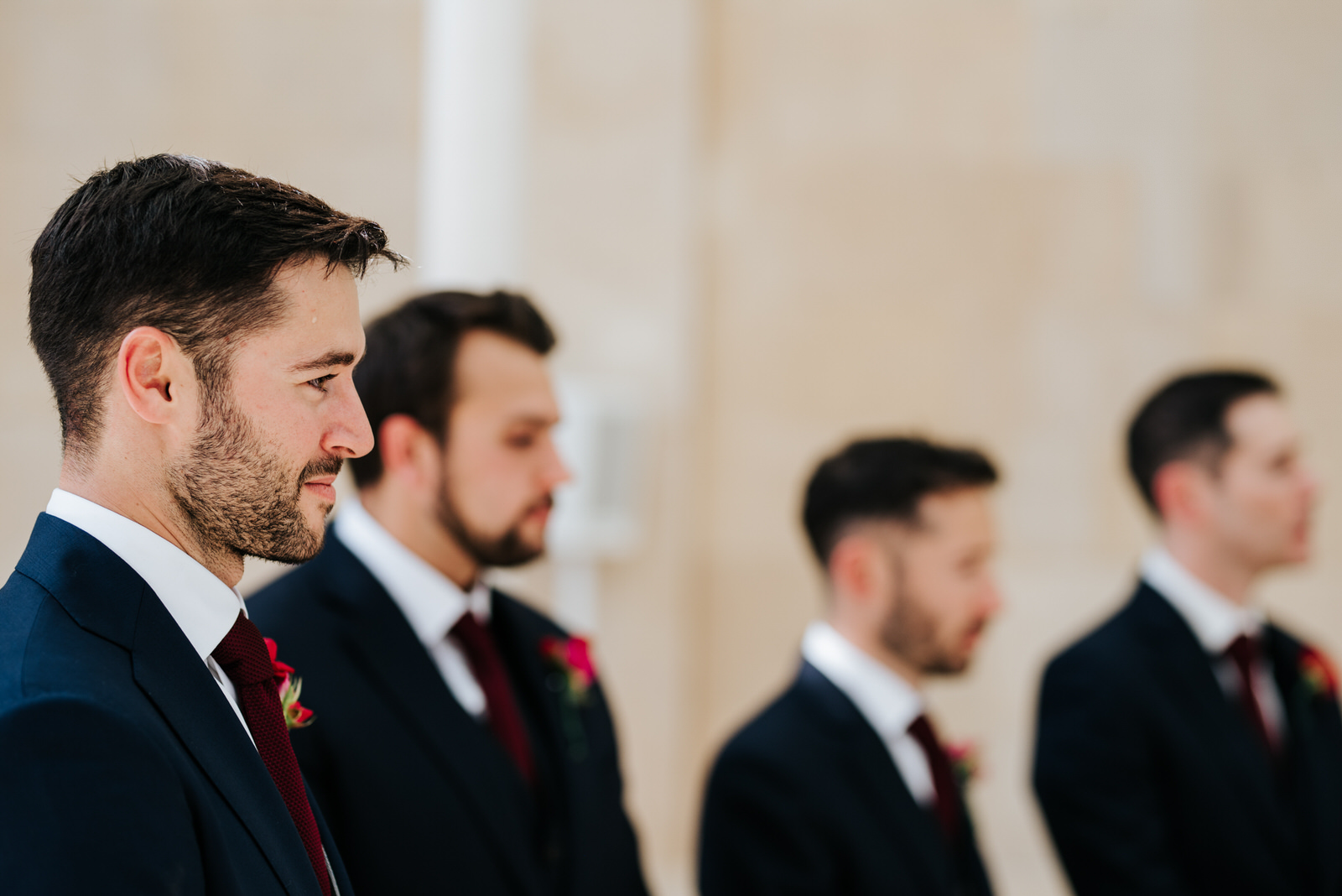  Close-up of groom waiting nervously at the front of the aisle as a drop of sweat goes down his forehead 